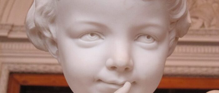 a close up of a statue of a child